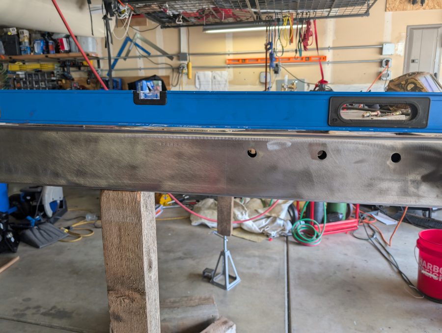 The main frame rails are 12'3" long and with an 8' level the curve is partially visible.